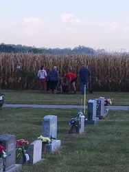 Youth planting tree at Wahoo Sunrise Cemetery